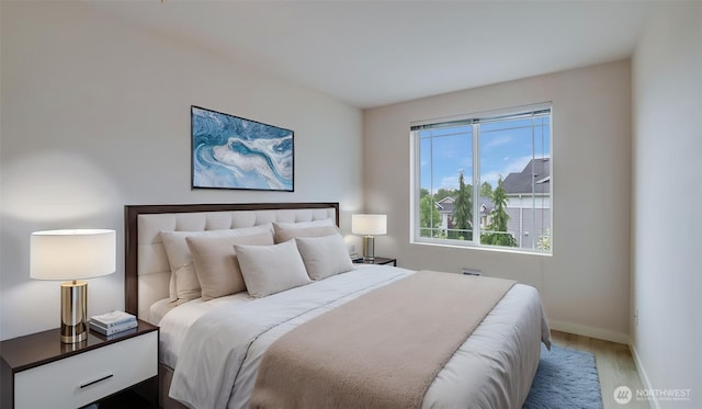 bedroom with wood finished floors and baseboards
