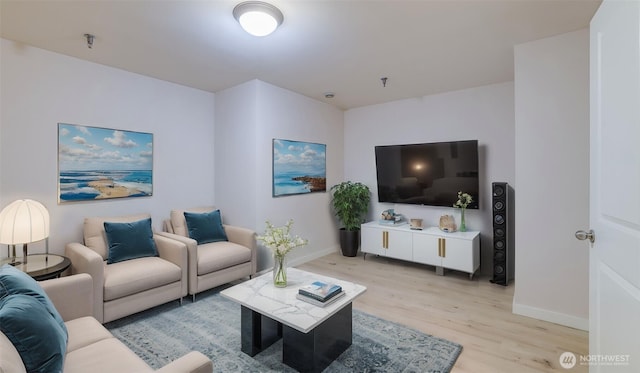 living area featuring light wood-type flooring and baseboards