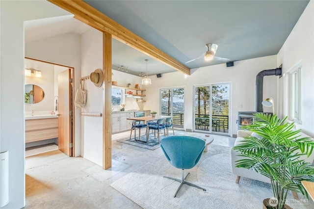 981 Nighthawk Ridge Ln, Leavenworth, WA 98826 - sunroom / solarium featuring beamed ceiling and a wood stove
