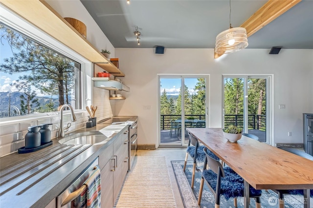 981 Nighthawk Ridge Ln, Leavenworth, WA 98826 - kitchen with stainless steel counters, open shelves, double oven range, hanging light fixtures, and tasteful backsplash