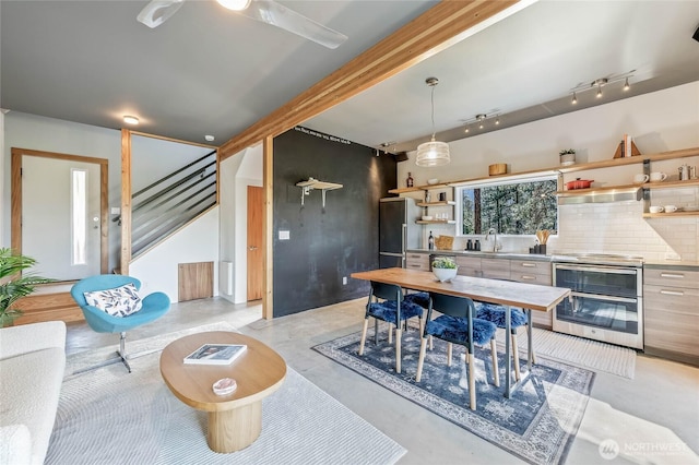 981 Nighthawk Ridge Ln, Leavenworth, WA 98826 - dining space featuring finished concrete flooring, rail lighting, and stairs