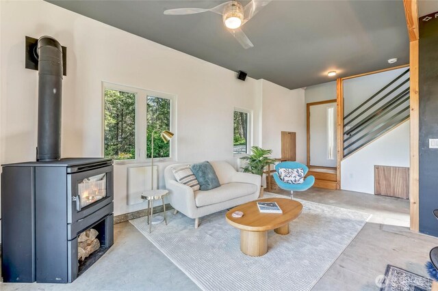 981 Nighthawk Ridge Ln, Leavenworth, WA 98826 - living room with concrete flooring, a wood stove, ceiling fan, and stairway