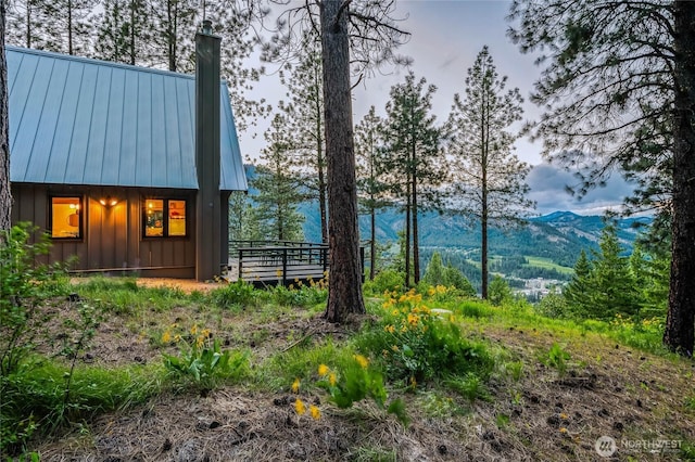 981 Nighthawk Ridge Ln, Leavenworth, WA 98826 - view of side of home with board and batten siding, a mountain view, a metal roof, a chimney, and a standing seam roof