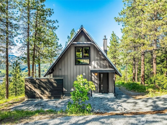 981 Nighthawk Ridge Ln, Leavenworth, WA 98826 - view of front of house featuring board and batten siding and a chimney