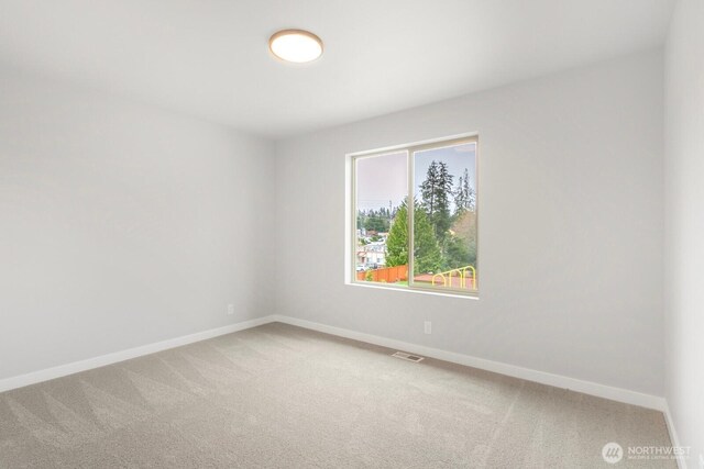 13302 SE 238th Pl Unit 7, Kent, WA 98042 - spare room featuring baseboards and light carpet