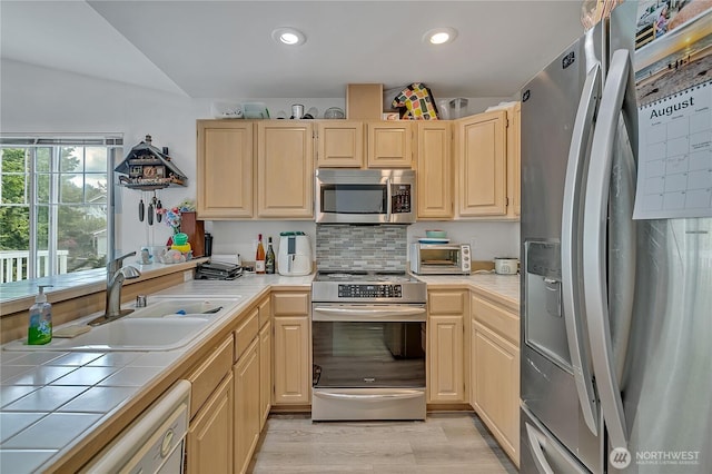 5400 Harbour Pointe Blvd Unit F202, Mukilteo, WA 98275 - kitchen with stainless steel appliances, tile countertops, a sink, light brown cabinetry, and recessed lighting