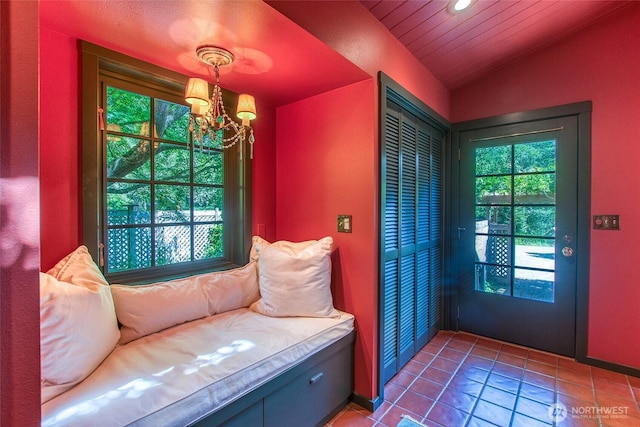 1472 White Beach Rd, Orcas Island, WA 98280 - doorway to outside with healthy amount of natural light, a chandelier, tile patterned flooring, vaulted ceiling, and recessed lighting