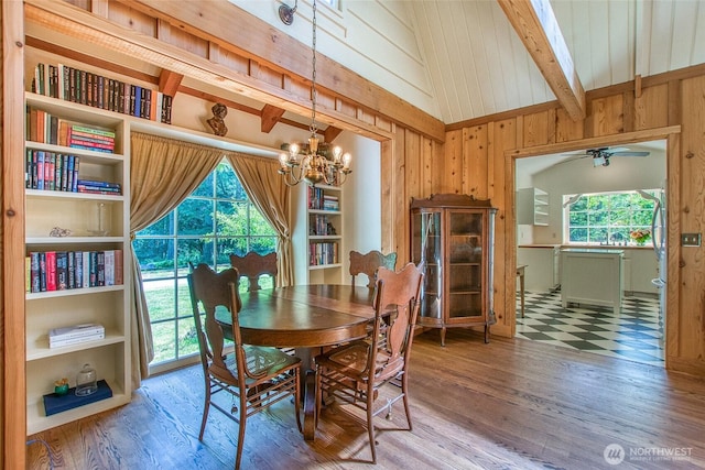 1472 White Beach Rd, Orcas Island, WA 98280 - dining area featuring a ceiling fan, wood walls, a chandelier, and wood finished floors