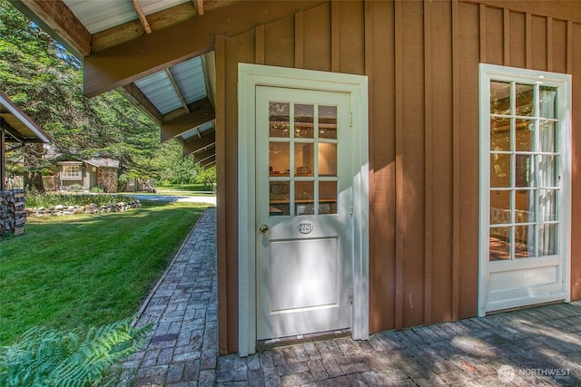 1472 White Beach Rd, Orcas Island, WA 98280 - view of exterior entry with board and batten siding and a yard