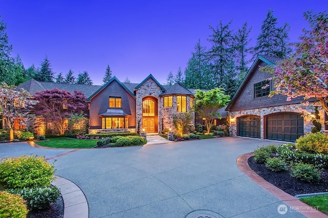 11211 Wachusett Rd, Woodway, WA 98020 - view of front of house with stone siding, driveway, and a garage