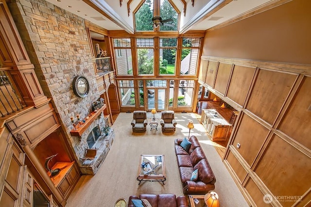 11211 Wachusett Rd, Woodway, WA 98020 - sitting room featuring ceiling fan, a large fireplace, a wainscoted wall, a decorative wall, and a towering ceiling