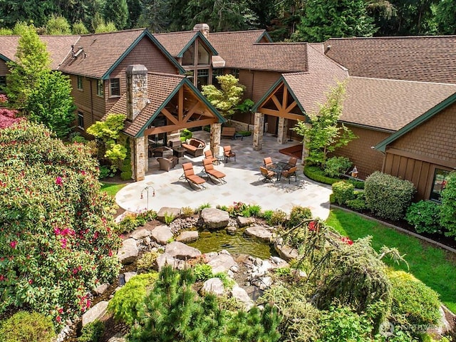 11211 Wachusett Rd, Woodway, WA 98020 - back of property featuring a patio, roof with shingles, and a chimney