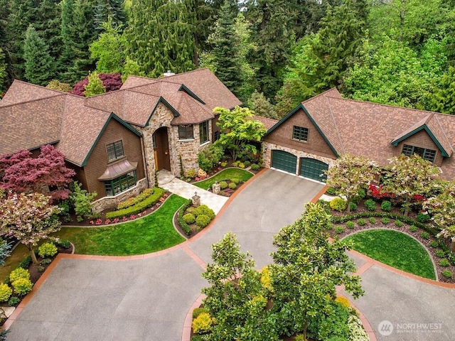 11211 Wachusett Rd, Woodway, WA 98020 - view of front of property featuring stone siding, driveway, a garage, a front lawn, and a shingled roof