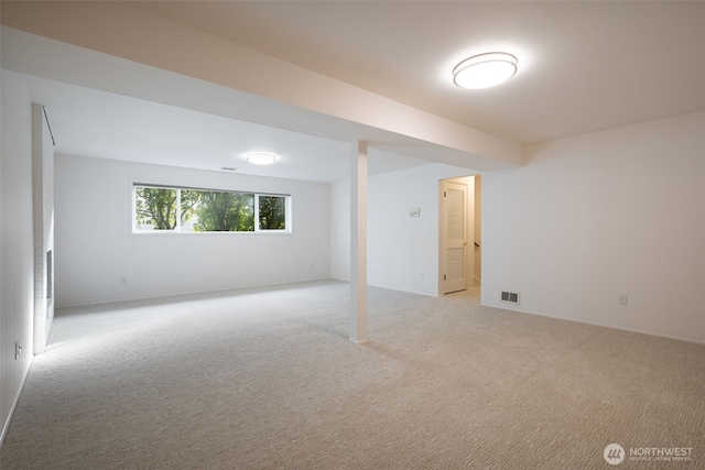 basement featuring light colored carpet