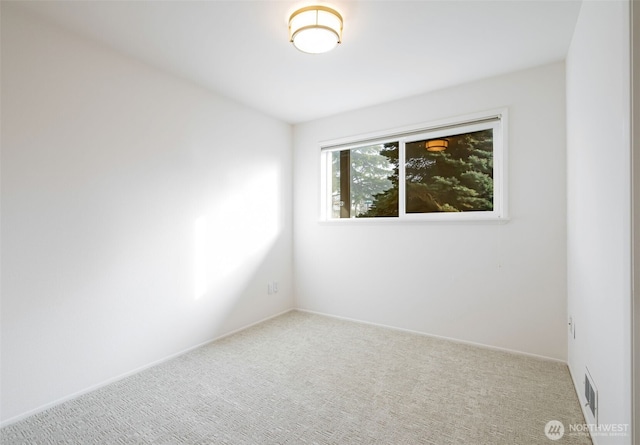 empty room with carpet flooring and baseboards