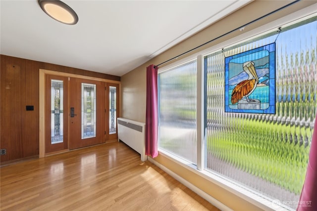301 S 6th St, Mount Vernon, WA 98274 - entryway with radiator heating unit, light wood-style flooring, healthy amount of natural light, baseboards, and wood walls
