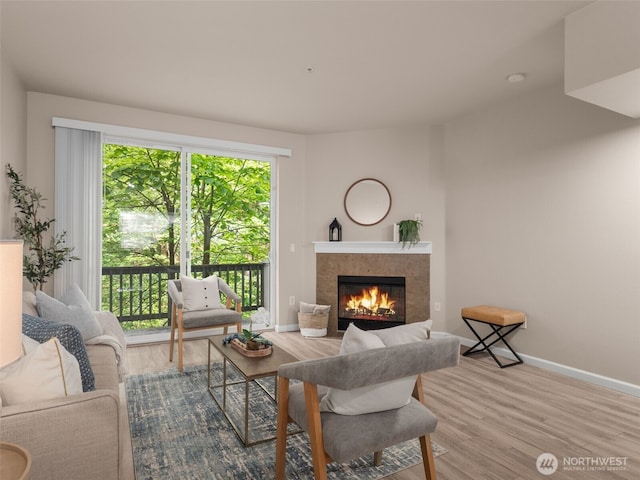 3116 164th St SW Unit 1804, Lynnwood, WA 98087 - living room with a tile fireplace, wood finished floors, and baseboards