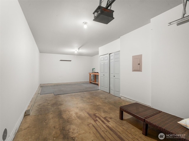 3116 164th St SW Unit 1804, Lynnwood, WA 98087 - garage featuring a garage door opener, electric panel, and baseboards