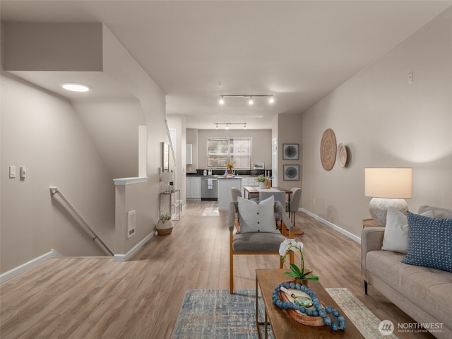 3116 164th St SW Unit 1804, Lynnwood, WA 98087 - living area featuring baseboards, light wood finished floors, and rail lighting