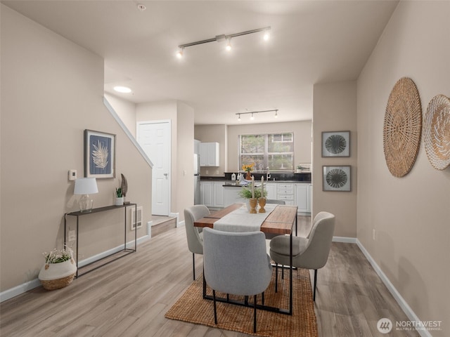 3116 164th St SW Unit 1804, Lynnwood, WA 98087 - dining room featuring track lighting, light wood-type flooring, and baseboards