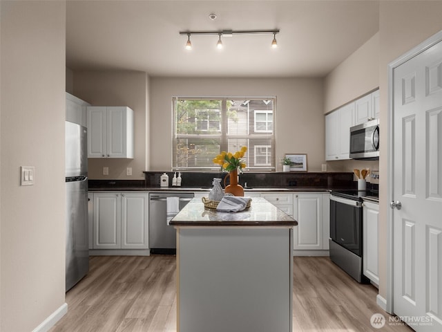 3116 164th St SW Unit 1804, Lynnwood, WA 98087 - kitchen featuring stainless steel appliances, light wood-style floors, and white cabinetry