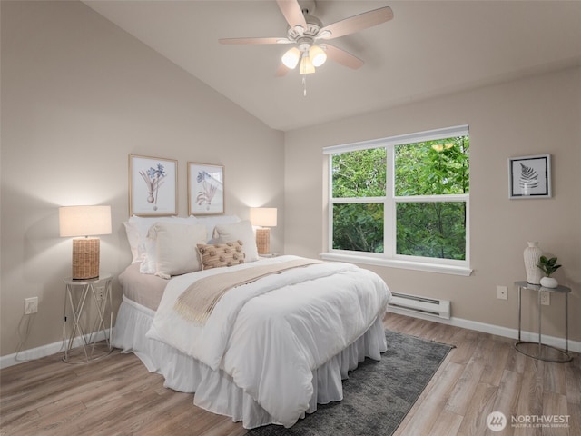 3116 164th St SW Unit 1804, Lynnwood, WA 98087 - bedroom featuring baseboard heating, vaulted ceiling, wood finished floors, baseboards, and ceiling fan