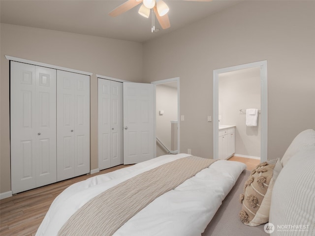 3116 164th St SW Unit 1804, Lynnwood, WA 98087 - bedroom with two closets, light wood finished floors, vaulted ceiling, connected bathroom, and baseboards