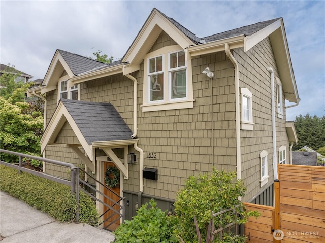 view of side of home featuring a shingled roof