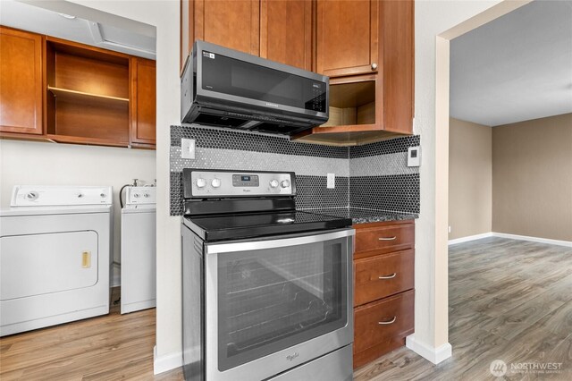 807 S Howard St, Tacoma, WA 98465 - kitchen featuring appliances with stainless steel finishes, open shelves, washer and dryer, light wood-style floors, and baseboards