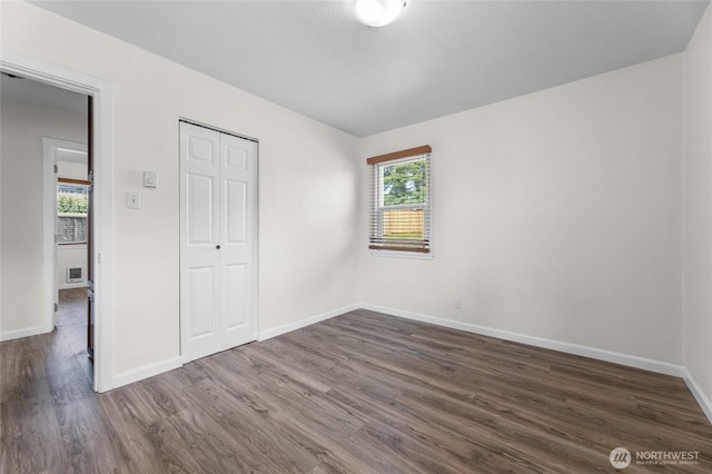 807 S Howard St, Tacoma, WA 98465 - unfurnished bedroom with dark wood finished floors, baseboards, and a closet