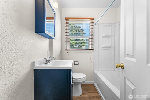807 S Howard St, Tacoma, WA 98465 - bathroom featuring wood finished floors, vanity, toilet, a textured wall, and baseboards
