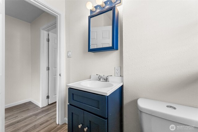 807 S Howard St, Tacoma, WA 98465 - bathroom featuring vanity, wood finished floors, toilet, and baseboards
