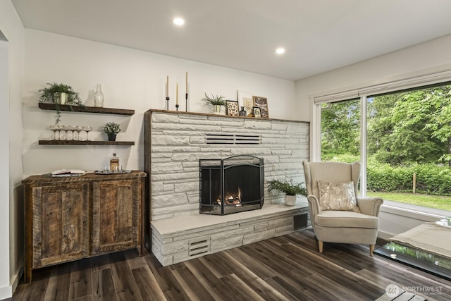 436 SE Maple Dr, North Bend, WA 98045 - living area with a stone fireplace, dark wood-type flooring, healthy amount of natural light, recessed lighting, and baseboards