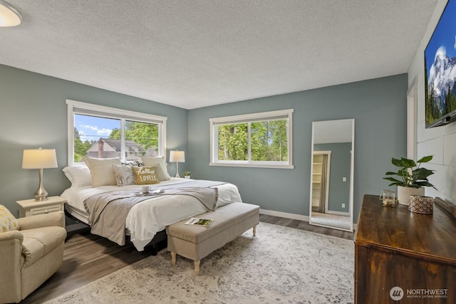 436 SE Maple Dr, North Bend, WA 98045 - bedroom featuring wood finished floors, a textured ceiling, and baseboards