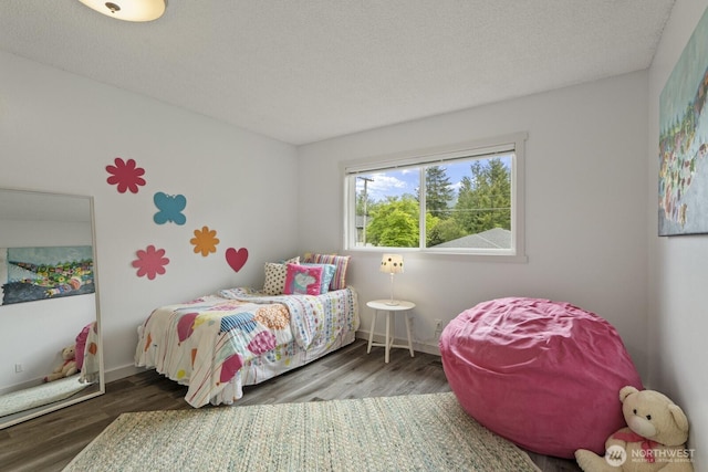 436 SE Maple Dr, North Bend, WA 98045 - bedroom with wood finished floors, baseboards, and a textured ceiling