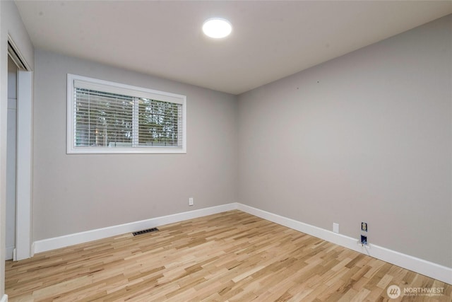 unfurnished room featuring light wood finished floors and baseboards
