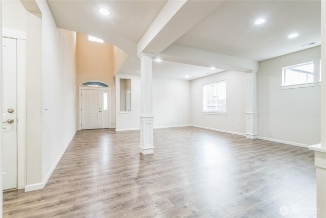 entryway featuring decorative columns, light wood-style flooring, baseboards, and recessed lighting