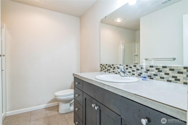 full bath with tile patterned floors, tasteful backsplash, a stall shower, baseboards, and toilet