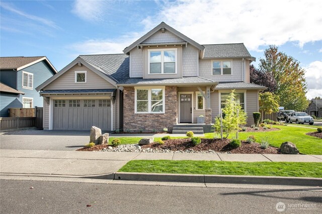 craftsman inspired home featuring concrete driveway and a garage