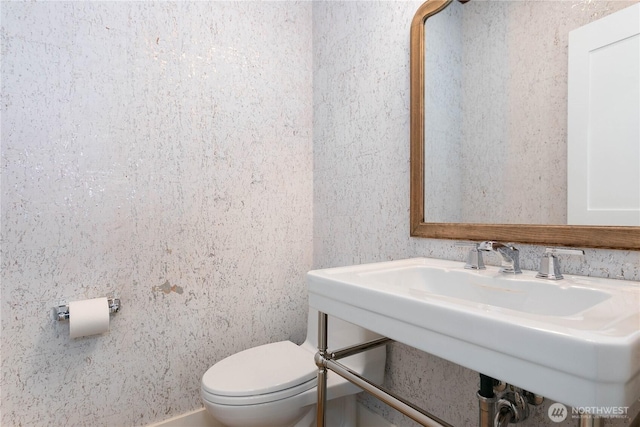 bathroom featuring toilet and a sink