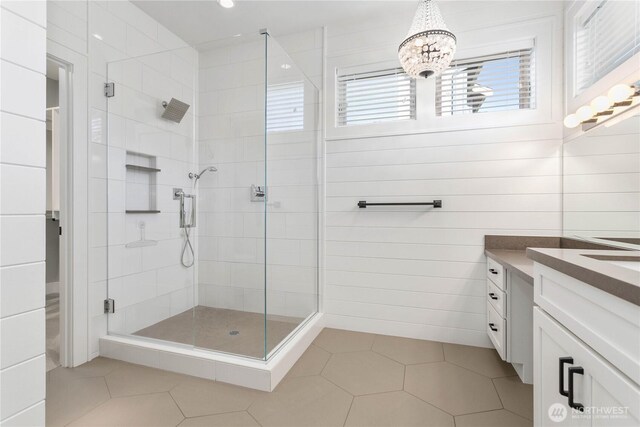 full bath with a stall shower, vanity, tile patterned flooring, a chandelier, and recessed lighting