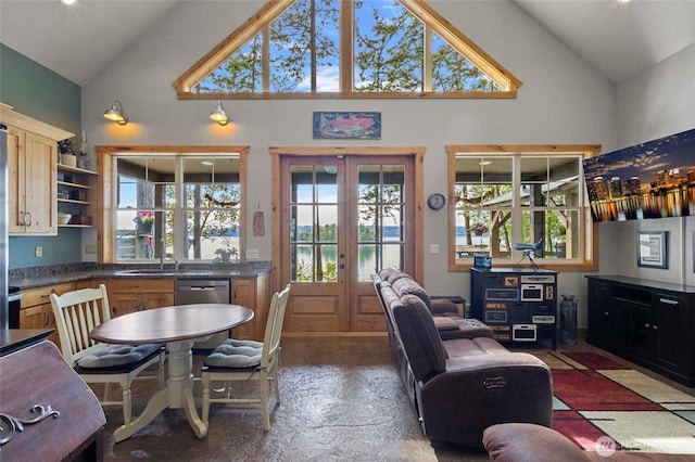 living area featuring high vaulted ceiling, healthy amount of natural light, and french doors