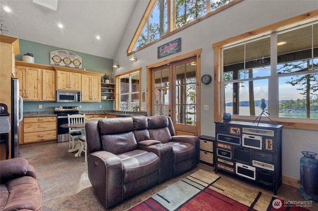 living area with high vaulted ceiling, plenty of natural light, french doors, and recessed lighting
