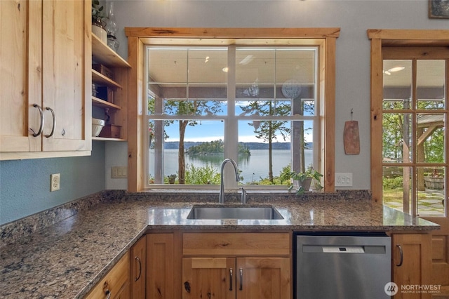 kitchen with dishwasher, a sink, open shelves, and dark stone counters