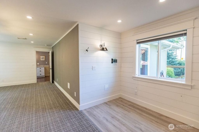 189 Hill Rd, Walla Walla, WA 99362 - unfurnished room with baseboards, recessed lighting, wood finished floors, wooden walls, and ornamental molding