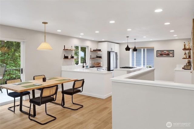 dining area featuring light wood-type flooring and recessed lighting