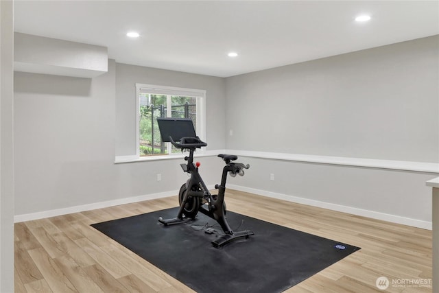 workout area with wood finished floors, recessed lighting, and baseboards