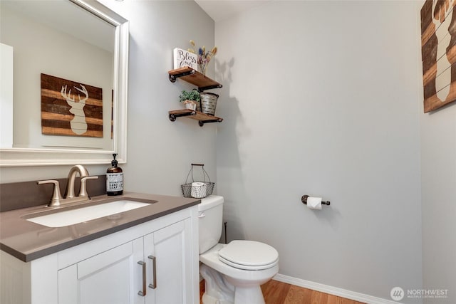 20121 3rd Ave NW, Arlington, WA 98223 - bathroom with toilet, vanity, wood finished floors, and baseboards