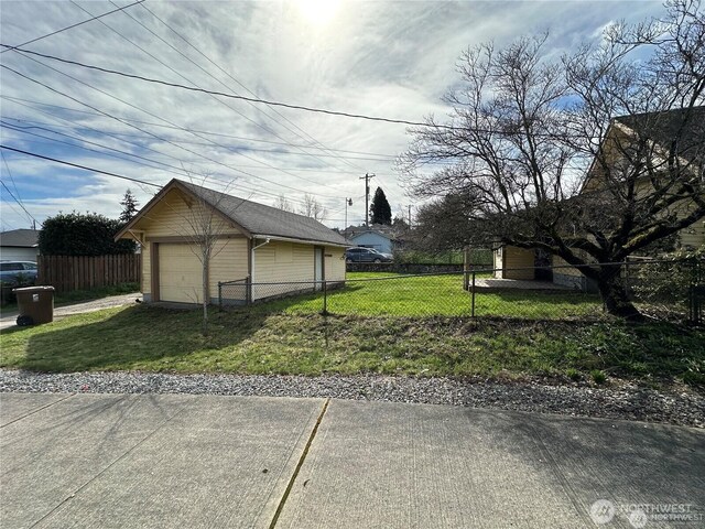 view of home's exterior featuring a garage, an outbuilding, and driveway