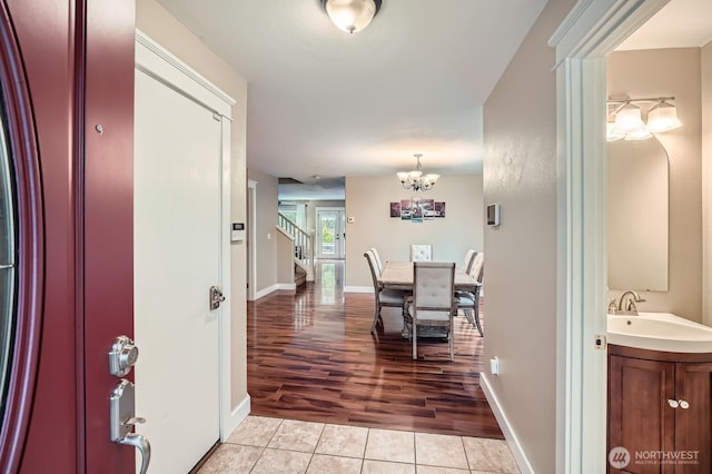 19702 99th Ct E, Bonney Lake, WA 98391 - entryway with a chandelier, stairway, light tile patterned floors, and baseboards
